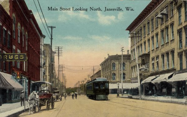 Color illustration of of a central street scene. A horse and wagon, automobile and streetcar in the street. A drug store in the lower left. A cigar store is on the right. Caption reads: "Main Street Looking North, Janesville, Wis."
