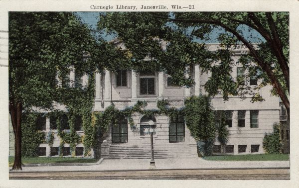 Colorized postcard view of an ivy-covered library. Caption reads: "Carnegie Library, Janesville, Wis."