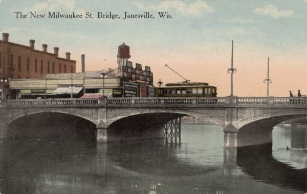 View of a concrete arch bridge crossing the Rock River in downtown Janesville.
