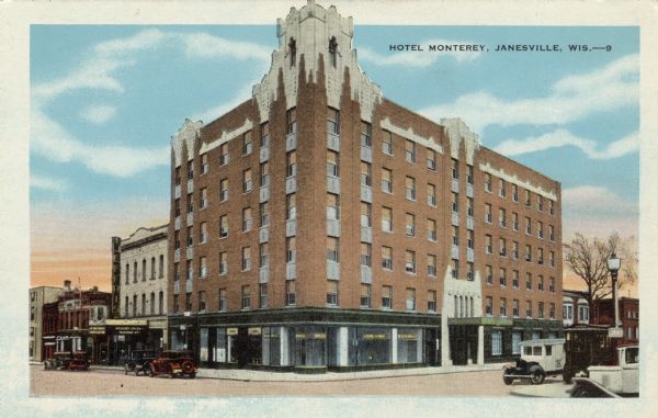 Colorized postcard view of a six-story corner hotel. Automobiles are parked at the curb. The cinema next door is showing Richard Arlen in "Burning Up." Caption reads: "Hotel Monterey, Janesville, Wis."
