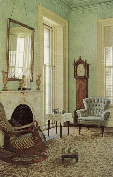 A corner of the Family Parlor with two chairs, a grandfather clock and a fireplace.

Text on reverse reads: "Abraham Lincoln visited here in 1859. The house was built in 1855-57, and was an important station on the Underground Railroad in pre-Civil War days. Its thirty-five rooms have been restored to their Civil War splendor by the Rock County Historical Society."