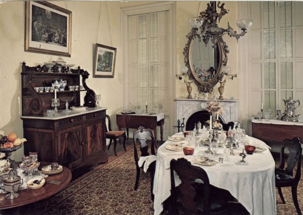 View of the formal dining room with the table set.  