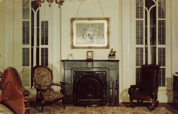 Interior of the Lincoln Bedroom at the Tallman House, with a marble fireplace, tall shuttered windows, and a bed at lower left.