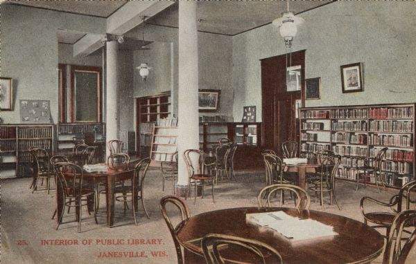 View of the reading room at the Public Library. Bookshelves are along the walls. Caption reads: "Interior of Public Library, Janesville, Wis."