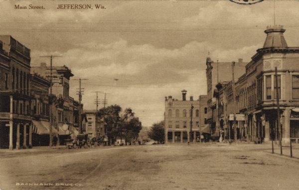 View of Main Street lined with commercial buildings. Caption reads: "Main Street, Jefferson, Wis."