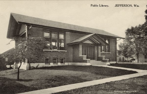 Exterior view of the entrance to the public library, built in the prairie style. Caption reads: "Public Library, Jefferson, Wis."