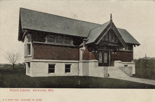 Exterior view of the public library, with a gable above the entrance. Caption reads: "Public Library, Kaukauna, Wis."