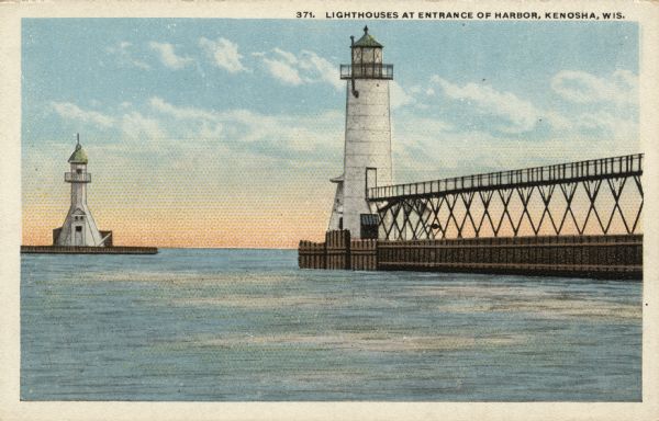 View toward the two lighthouses on either side of Kenosha Harbor. The lighthouse on the right has an elevated walkway to the entrance. Caption reads: "Lighthouses at Entrance of Harbor, Kenosha, Wis."