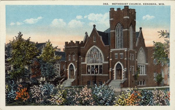 Hand-colored postcard of a Methodist Church with two front entrances. The windows have Gothic arches. Caption reads: "Methodist Church, Kenosha, Wis."