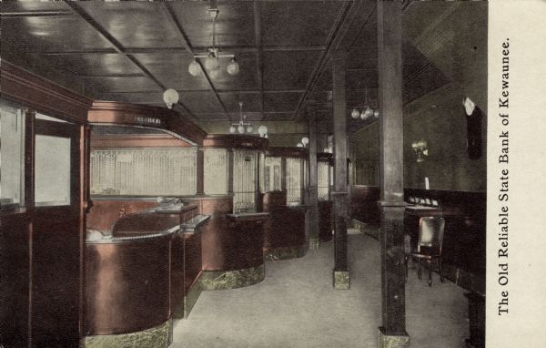 View of the interior of a bank, with a row of teller cages on the left, and columns on the right. The president's office is on the far left. Caption reads: "The Old Reliable State Bank of Kewaunee."