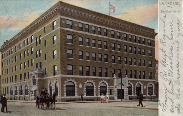 View across intersection toward the hotel. Caption reads: "La Crosse, Wis. Stoddard Hotel." Text on reverse reads: "STODDARD HOTEL, an absolutely fireproof structure of brick, steel and stone, was built by a company of wealthy citizens, in response to a popular demand for a first-class hotel. It cost $240,000 and is one of the finest of the smaller hostelries of the northwest. The site upon which it stands was purchased by popular subscription, costing $20,000 and was donated to the builders of the hotel."