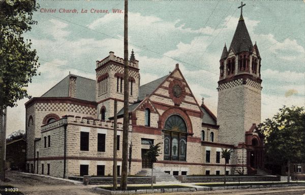 Corner view of a large stone church with an arched window of stained glass, and a steeple on the right. Caption reads: "Christ Church, La Crosse, Wis."
