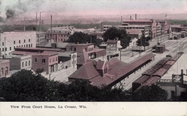 Elevated view from the Court House of central La Crosse. The depot is in the foreground, and a Carriage and Buggy manufacturer is in the background. Caption reads: "View from Court House, La Crosse, Wis."