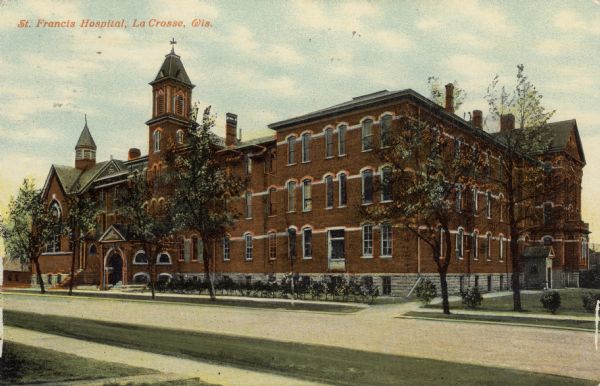 Hand-colored view across street towards the St. Francis Hospital and chapel. Caption reads: "St. Francis Hospital, La Crosse, Wis."