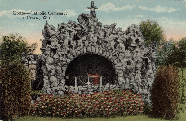Hand-colored view of the grotto in the Catholic Cemetery. Caption reads: "Grotto &#8212; Catholic Cemetery, La Crosse, Wis."