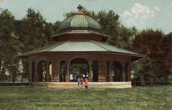 Hand-colored view of the pavilion in Pettibone Park. A group of children are posing in front of the pavilion. Caption reads: "Pavilion, Pettibone Park, La Crosse, Wis."