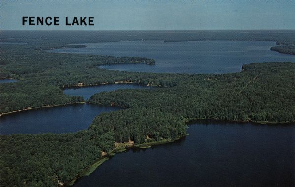 Aerial view of Fence Lake, one of the largest lakes in northern Wisconsin. Caption reads: "Fence Lake."