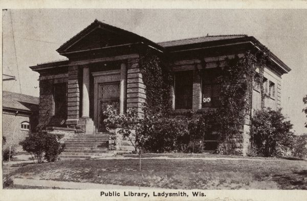 View of the public library with ivy covered walls. Caption reads: "Public Library, Ladysmith, Wis."