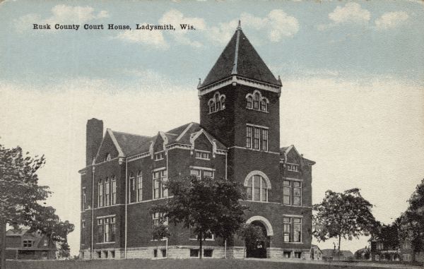 View across lawn toward the courthouse. Caption reads: "Rusk County Court House, Ladysmith, Wis."