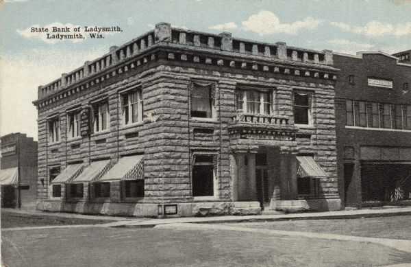 View from intersection towards a bank on the corner. Caption reads: "State Bank of Ladysmith, Ladysmith, Wis."