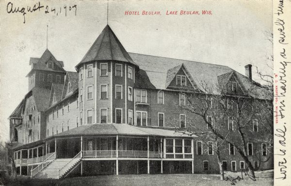 View of a large hotel, with a wrap-around porch and a turret at the corner. Caption reads: "Hotel Beulah, Lake Buelah, Wis."