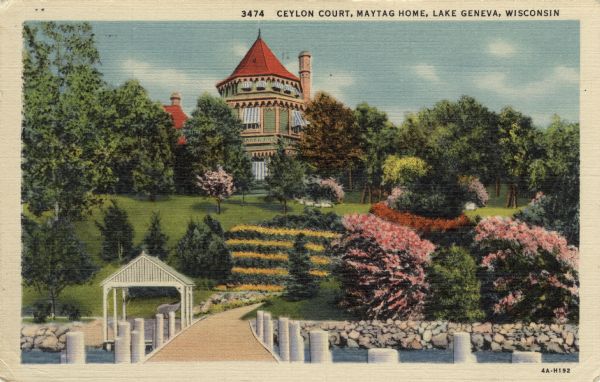 Colorized postcard view from pier towards a private lakeside home on a hill, with a large garden leading down to the lake. Caption reads: "Ceylon Court, Maytag Home, Lake Geneva, Wisconsin."