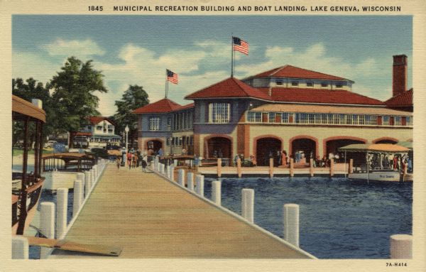 Colorized postcard view from pier towards a large recreation building. The excursion boat "Miss Geneva" is under an awning on the right. Caption reads: "Municipal Recreation Building and Boat Landing, Lake Geneva, Wisconsin."
