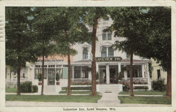 View across street toward a hotel and restaurant on a tree-lined street. Caption reads: "Lakeview Inn, Lake Geneva, Wis."