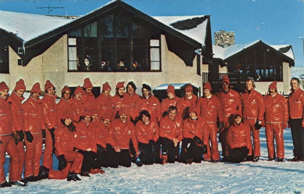 A group of ski instructors assembled for an outdoor group portrait. Text on reverse reads: "Every year thousands of students learn to ski in lessons from these professional ski instructors. The Ray T. Stemper Ski Schools are operating under the direction of Jim Engel at Playboy Club and Majestic Hills in Lake Geneva, Wisconsin, and at Little Switzerland in Slinger, Wisconsin."
