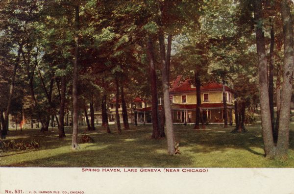 View across lawn towards a lakeside resort among trees. Caption reads: "Spring Haven, Lake Geneva, (Near Chicago)."
