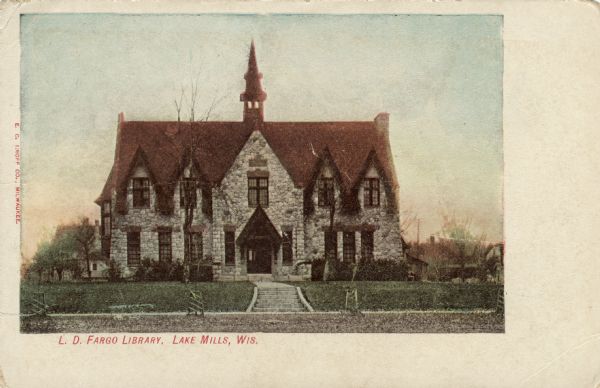 Hand-colored postcard of the facade of the L.D. Fargo Library. Caption reads: "L. D. Fargo Library, Lake Mills, Wis."