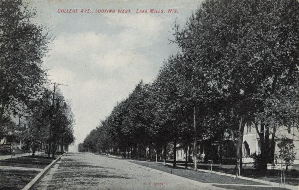View of tree-lined residential street. The houses have porches. Caption reads: "College Ave., Looking West, Lake Mills, Wis."