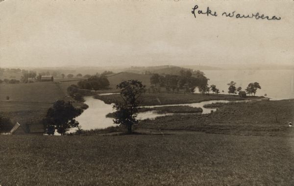 View of Lake Waubesa from a hill. A farm is in the distance on the left. The Yahara River is in the foreground. Handwritten caption reads: "Lake Waubesa."