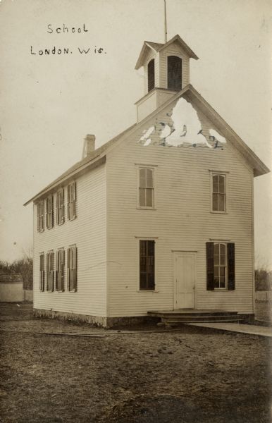 View of a two-story wood frame school with shuttered windows and a bell tower. Caption reads: "School, London, Wis."
