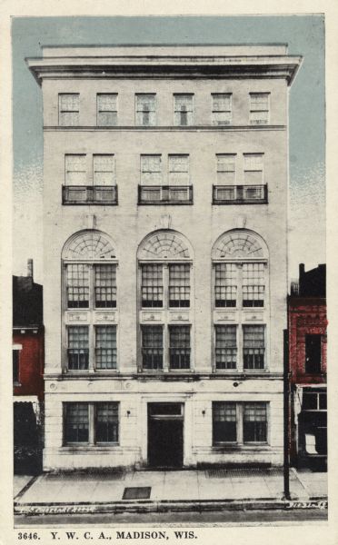 Five-story white stone building in the middle of a city block. Caption reads: "Y. W. C. A., Madison, Wis."