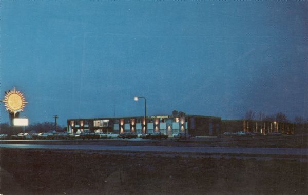 Twilight view of a motel located at the junction of U.S. 12 & 18 at I-90.