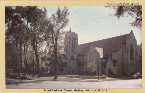 View across street towards the Lutheran Church located at 312 Wisconsin Avenue. Automobiles are parked at an angle at the curb. Caption Reads: "Bethel Lutheran Church, Madison, Wis."