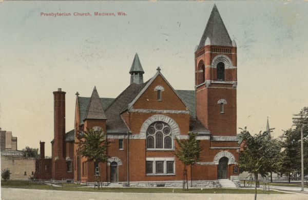 Hand-colored exterior view of the church located on Wisconsin Avenue. The church has red brick with Romanesque arches. Caption Reads: "Presbyterian Church, Madison, Wis."