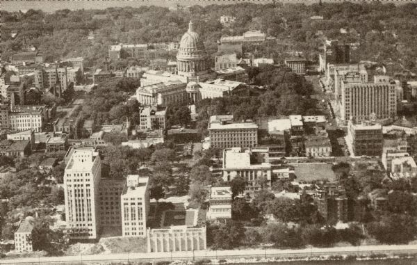 Aerial view of Capitol Square with Lake Monona in the foreground and Lake Mendota in the background. Pinckney Street is on the right.