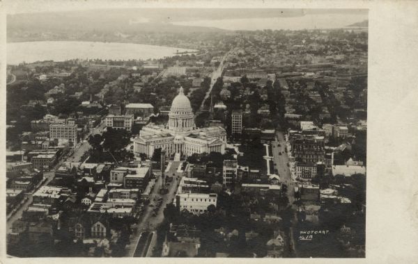 Aerial view of Capitol Square and surrounding area from East Washington Avenue. The old water tower in the center. Lake Monona is on the left; Lake Mendota is on the right.