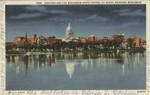 Twilight view of the Madison skyline across Lake Monona. Caption reads: "Madison and the Wisconsin State Capitol at Night, Madison, Wisconsin."