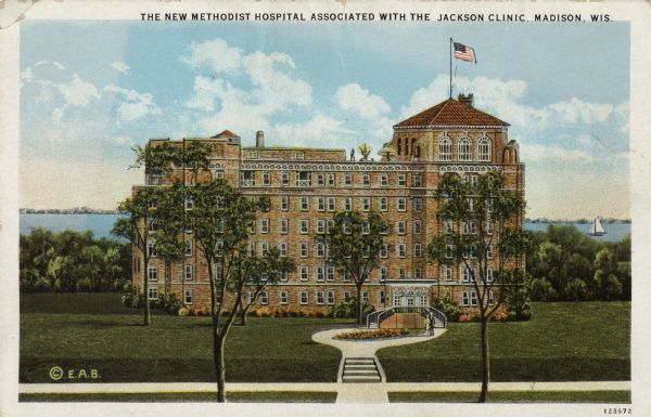 Color illustration of a six-story hospital next to a lake. "Caption reads: "The New Methodist Hospital Associated with the Jackson Clinic, Madison, Wis."