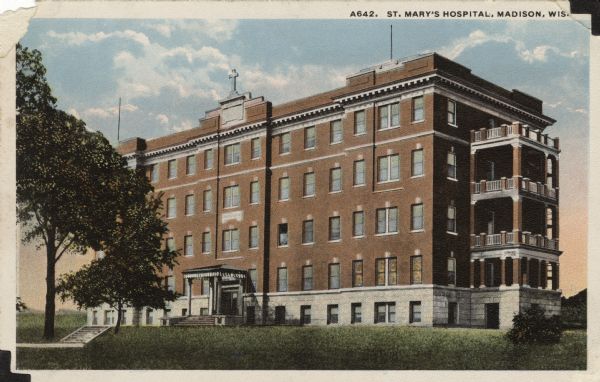 Exterior view of St. Mary's Hospital, a four-story brick building with balconies on the right side. Caption reads: "St. Mary's Hospital, Madison, Wis."