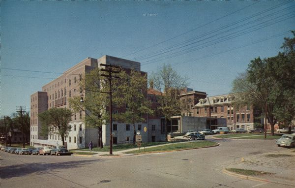Exterior view of the hospital located at 925 Mound Street. Automobiles are parked along the curb.