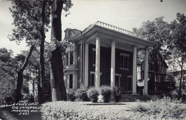 Exterior view of the Georgian style house. The entry is flanked by four columns. Caption reads: "The Georgian, 216 Langdon Street, Madison, Wis."