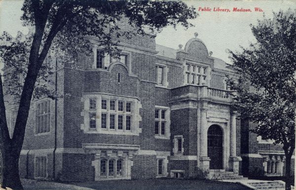 Exterior view of the Madison public library, a brick building with an arched entrance. Caption reads: "Public Library, Madison, Wis."