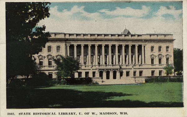 Hand-colored postcard of the State Historical Society building facing the grassy lawn of the library mall. Caption reads: "State Historical Library, U. of W., Madison, Wis."