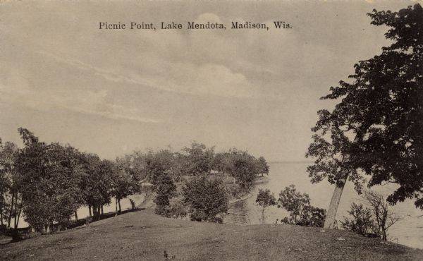 Sepia-toned photographic postcard view looking out towards the Picnic Point Peninsula jutting out into Lake Mendota. A walking path is on the left Caption reads: "Picnic Point, Lake Mendota, Madison, Wis."