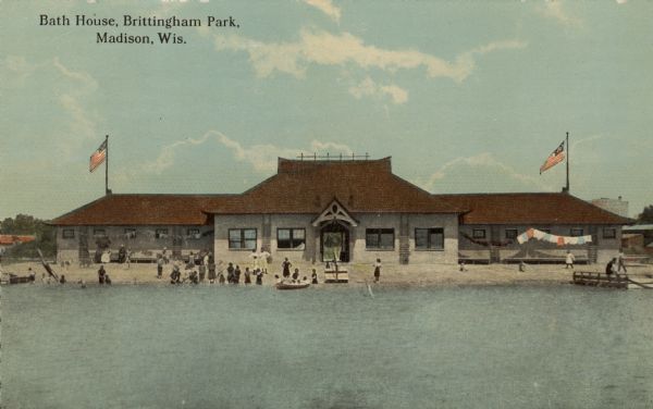 View across water towards the bath house and bathing beach at Brittingham Park on Monona Bay. Caption reads: "Bath House, Brittingham Park, Madison, Wis."