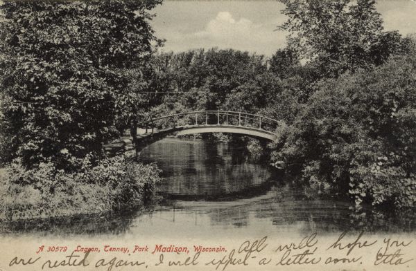 View of the foot bridge crossing the lagoon at Tenney Park. Caption reads: "Lagoon, Tenney Park, Madison, Wisconsin."